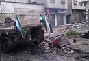 Fotografía falicitada por los Comités de Coordinación Locales de Siria en la que se ve a un soldado rebelde junto a un blindado gubernamental en la ciudad de Homs, Siria