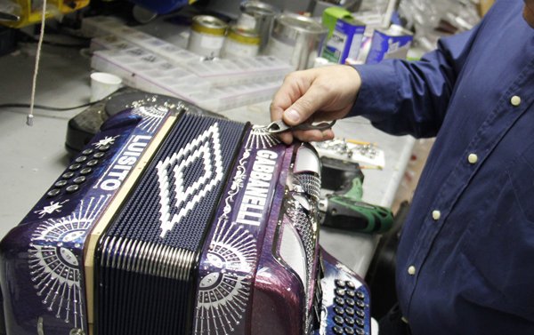 Los clientes pueden personalizar sus acordeones con diferentes colores, grabados e imágenes. Todo el trabajo se hace a mano. Aquí Mike Gabbanelli entalla los cristales Swarovski en uno de sus instrumentos.