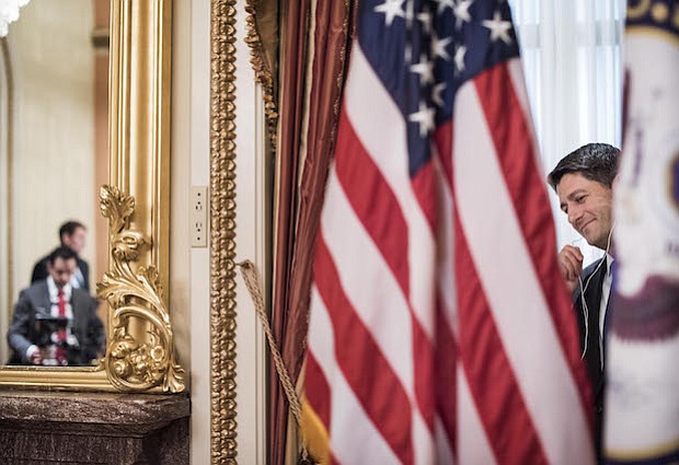 El presidente de la Cámara de Representantes Paul Ryan, R-Wis., hace llamadas en su oficina ceremonial el primer día del 115º Congreso el martes.