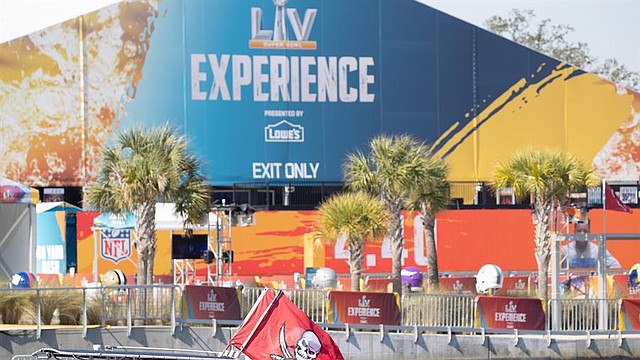 DEPORTE. Un fan de los Tampa Bay Buccaneers muestra una bandera en su barco mientras pasa por el complejo de la Super Bowl Experience. | Foto: Efe.