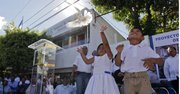 Una niña lanza una paloma como símbolo de paz durante un acto simbólico junto a miembros de las pandillas Mara Salvatrucha (MS) y Barrio 18 el martes 22 de enero.