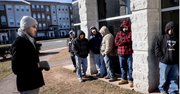 Marley Pulido, a commumity organizer at the Labor Resource Center, speaks to day laborers in Centreville, Va. Pulido was trying to convince the men to come to the center to stay warm and have a better chance of finding work. 
