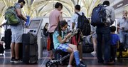 Aug. 15, 2015 After standing in line with for an hour and a half, Alisha Lalani, 10, of Ft. Lauderdale, Fla., looks at her phone as her mother and brother check in for their flight to Miami at Washington's Reagan National Airport.