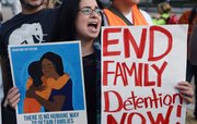 Una mujer sostiene una pancarta durante una manifestación para poner fin a deportaciones el jueves 22 de octubre 2015, en Washington.