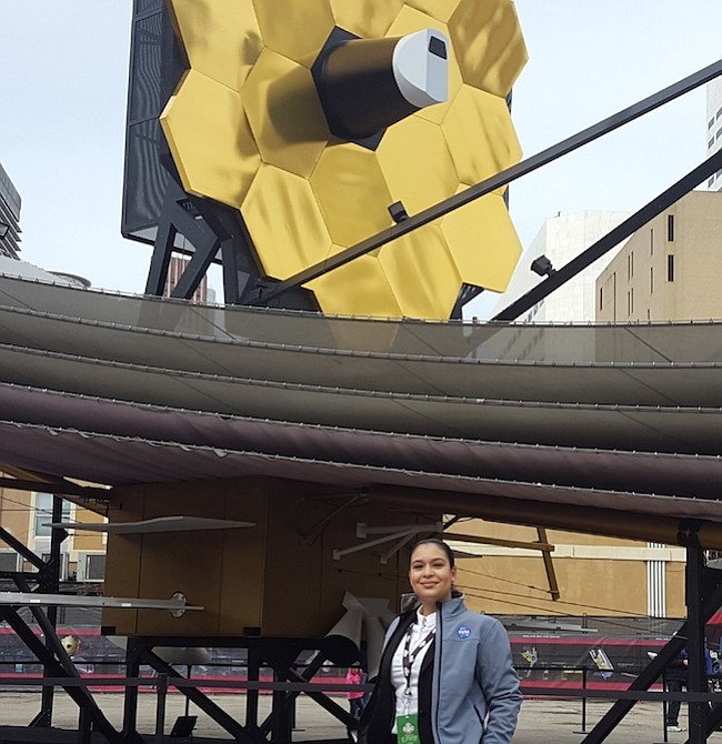 Ingeniera. Scarlin Hernández, nacida en República Dominicana, posando junto al modelo del telescopio espacial que será lanzado en el 2019, es una las poquísimas ingenieras que trabaja en el programa aeroespacial de la NASA.