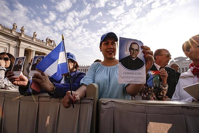 ROMA. Una fiel sostiene una imagen de Óscar Romero antes de la misa de canonización en el Vaticano, el 14 de octubre de 2018