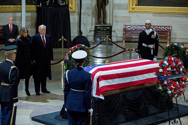 El presidente de los Estados Unidos, Donald J. Trump (3-i), y la primera dama, Melania Trump (2-i), presentan sus respetos a los restos mortales del ex presidente estadounidense George H. W. Bush (1989-1993)