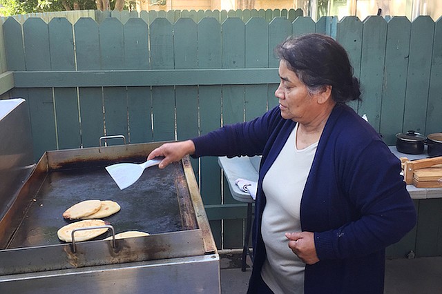 María Contreras prepara pupusas para el negocio de su familia de venta de comida. El objetivo es ayudar a reemplazar los ingresos de su hermano, un trabajador de la construcción que está detenido en el Adelanto ICE Processing Center, en el sur de California, desde junio pasado.