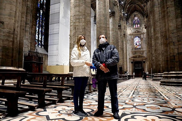 MEDIDAS. Los turistas con máscaras visitan la Catedral de Milán (Duomo di Milano), que fue reabierta al público después de estar cerrada durante una semana debido al nuevo brote de coronavirus Covid-19 en el país, en Milán, al norte de Italia, el 2 de marzo de 2020